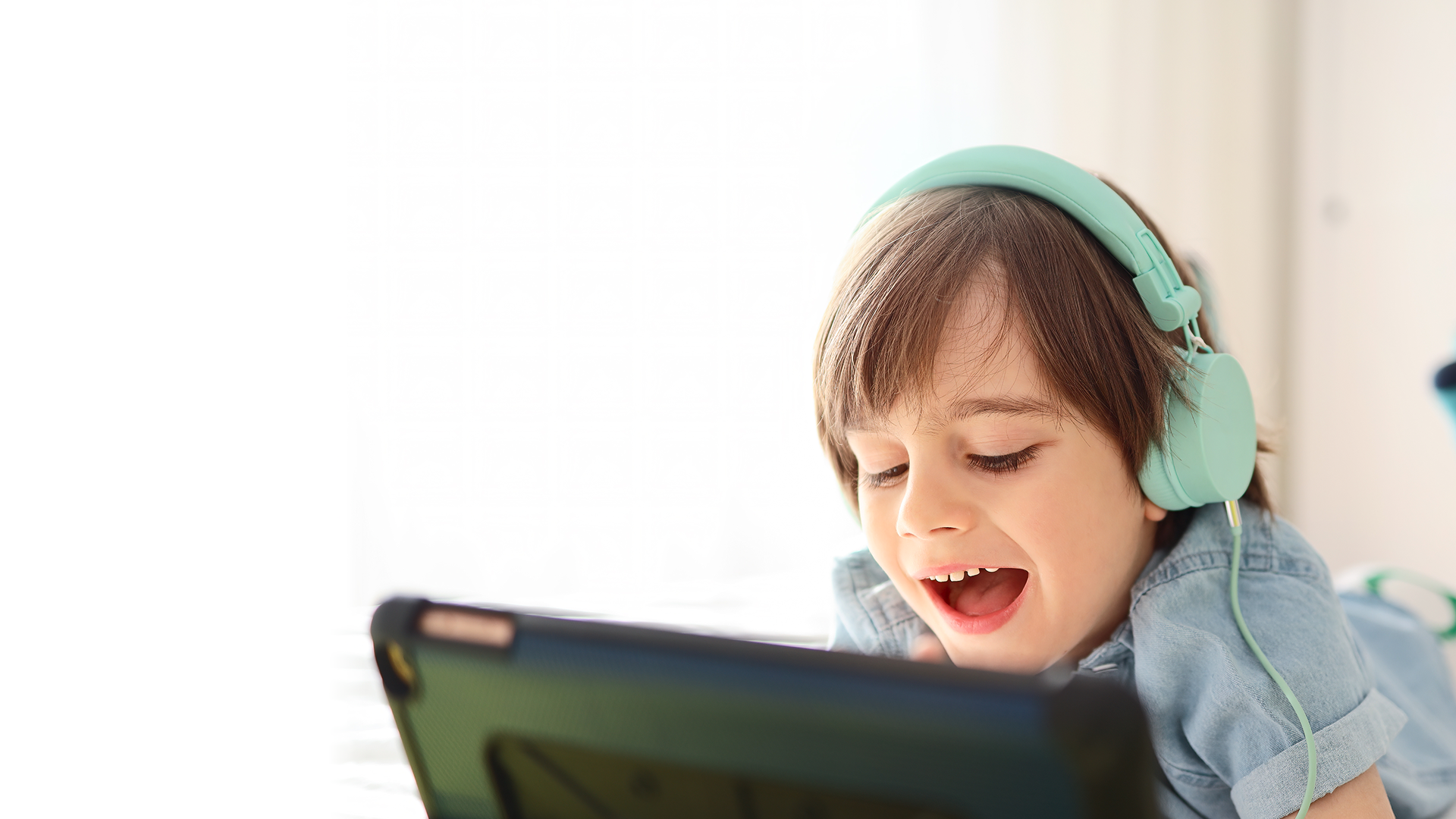 Child playing verboso games on tablet having fun