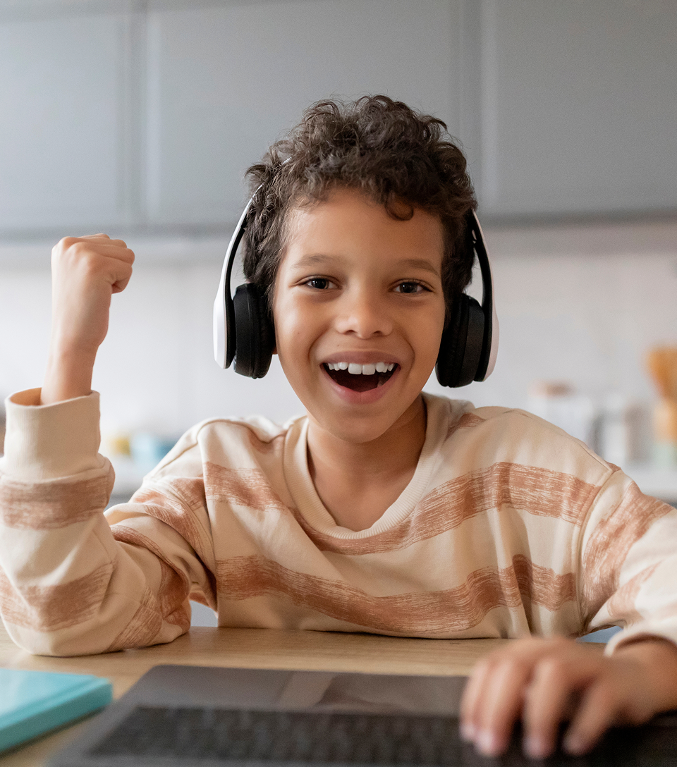 Child wearing headphones and smiling